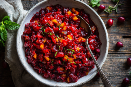 The best fresh cranberry relish recipe in a white ceramic bowl, showing its chunky texture and vibrant red color.