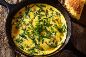 Freshly cooked ramps and eggs in a skillet, a classic Southern foraging recipe.
