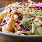 High-angle close-up of creamy easy coleslaw recipe in a bowl on a dining table