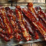 Million dollar bacon with caramelized brown sugar glaze on a wire cooling rack
